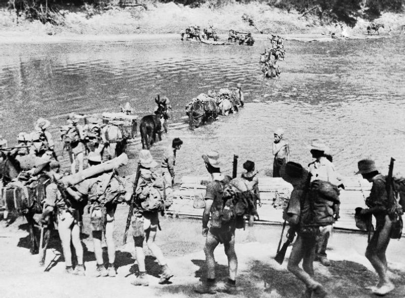 Chindit Operations - General: A Chindit column crossing a river in Burma, 1943.