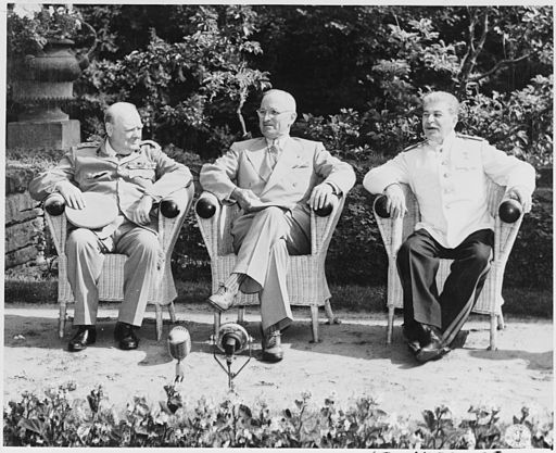British Prime Minister Winston Churchill, President Harry S. Truman, and Soviet leader Josef Stalin in the garden of Cecilienhof Palace before meeting for the Potsdam Conference.