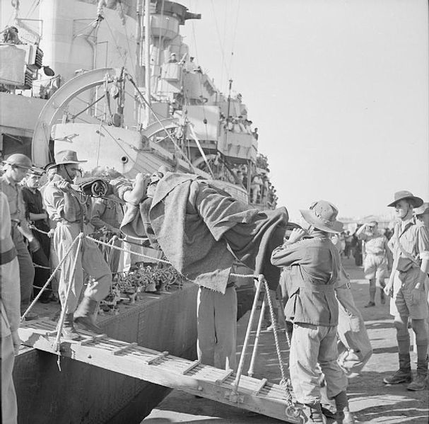 A wounded Commonwealth soldier being brought ashore on a stretcher at an Egyptian port after the evacuation from Crete